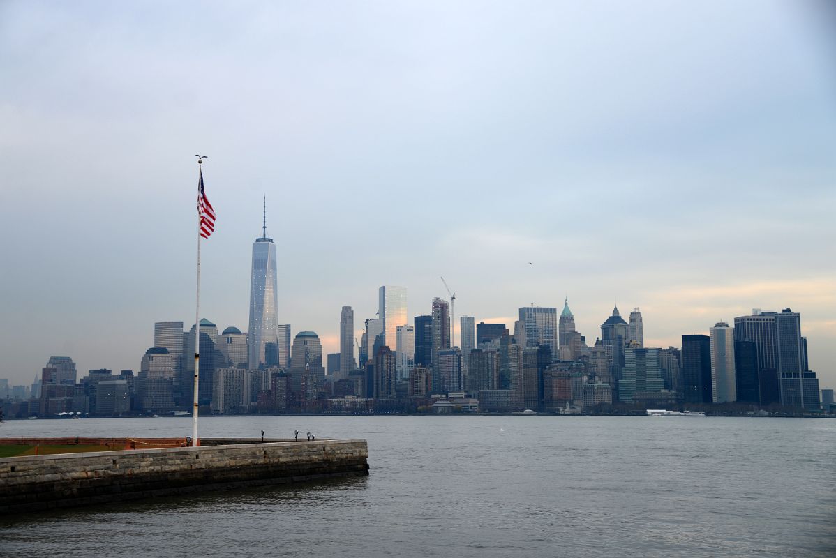 12-20 Hudson River, World Trade Center And Manhattan Financial District And US Flag Leaving Ellis Island